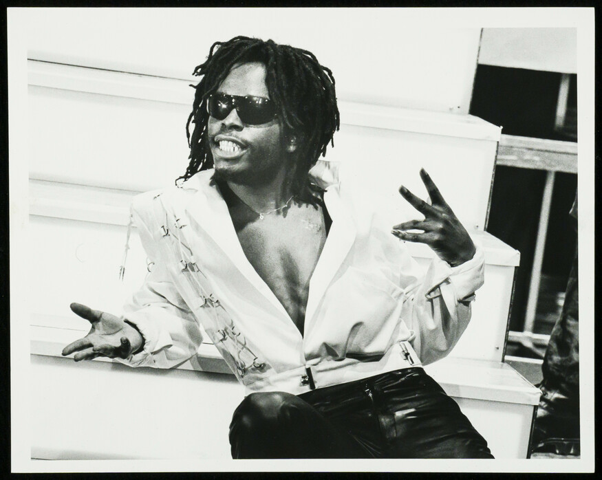 A young man with dreads and sunglasses
