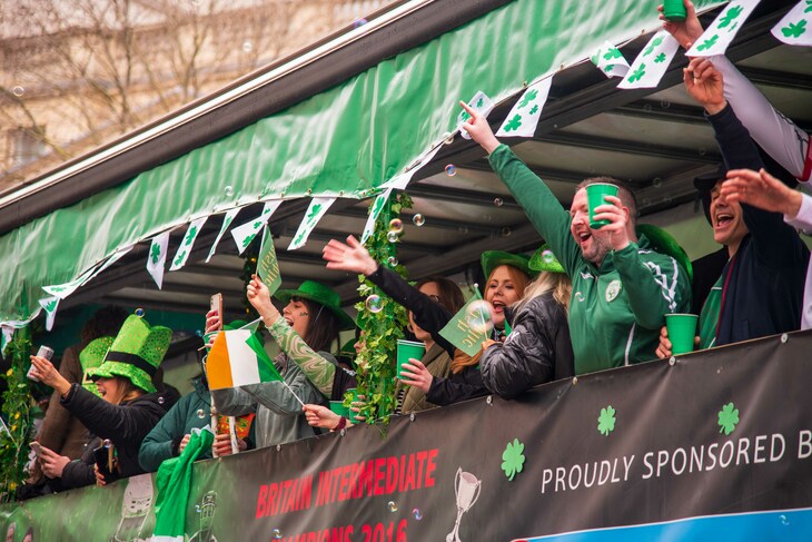 People dressed in green celebrating on a float