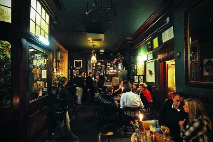 Dark interior of an Irish pub with lots of people