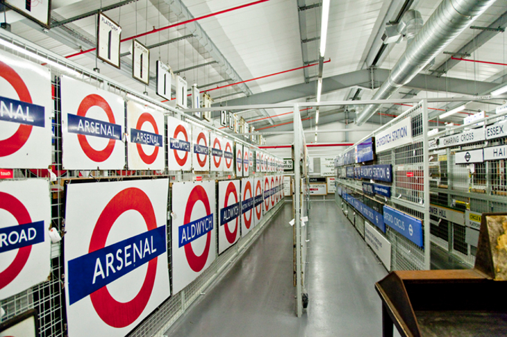 A row of tube roundels displayed on a corridor wall