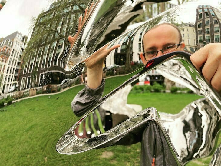 Free and cheap things to do: a reflection in a distorted but shiny sculpture