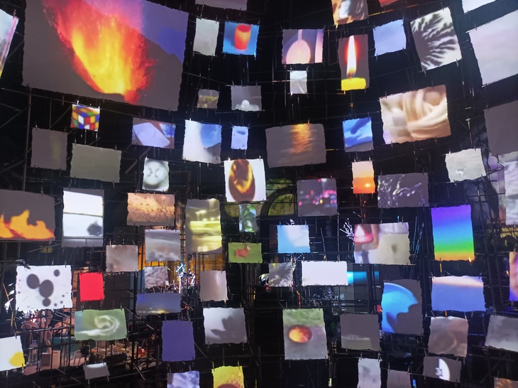 Lots of screens made from paper fragments with various pictures projected onto them