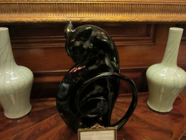 An elegant sculpture of a black cat