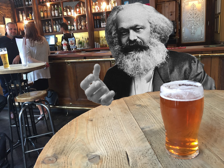 Karl Marx talking in a pub with a pint