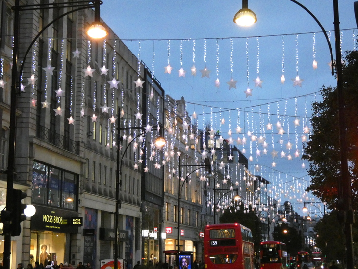 Stars strung over Oxford Street - a red bus drives underneath