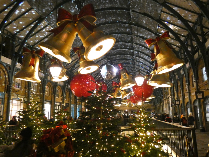 Huge bells and red baubles hang from the ceiling of Covent Garden Market