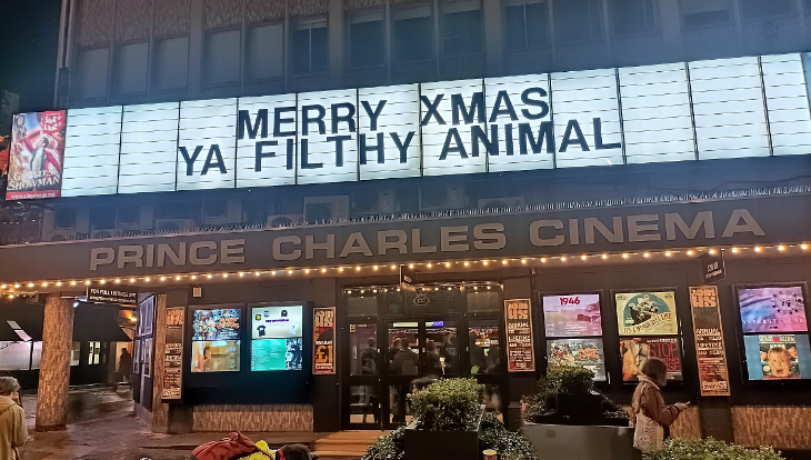 Cinema exterior with 'Merry Xmas ya filthy animal' written on the lightbox
