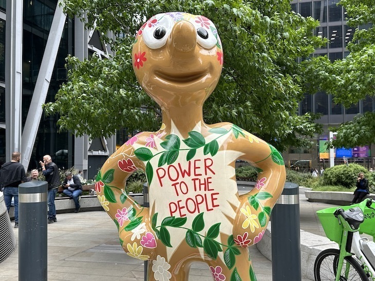 A sculpture of Morph with 'power to the people' written on its chest