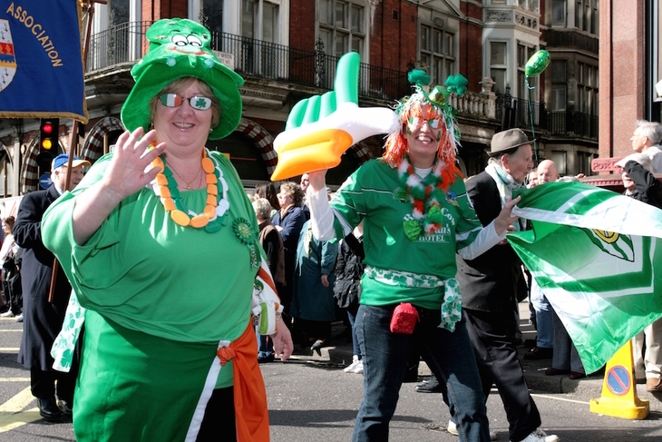 St Patrick's Day in London: People wearing green smiling and taking part in the St Patrick's day parade