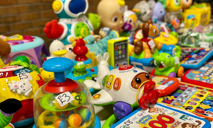 A table laid out with various children's toys and games