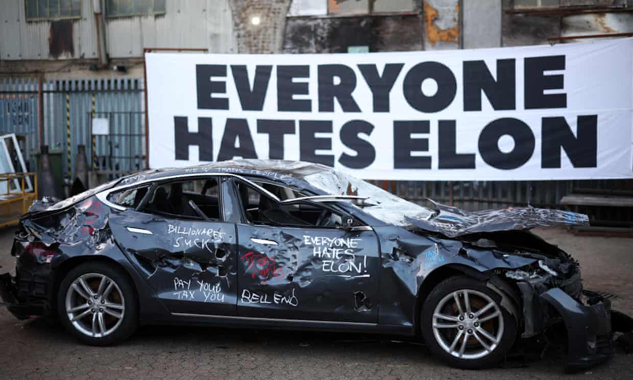 Headline: Artistic Fury: London Protesters Bash Tesla in Bold Statement Against Billionaire Politics