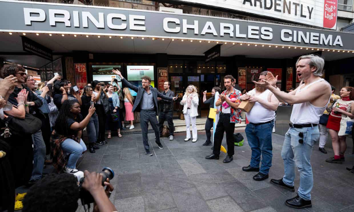 Headline: Cage Convergence: Over 100 Lookalikes Celebrate Eccentricity Outside London Cinema
